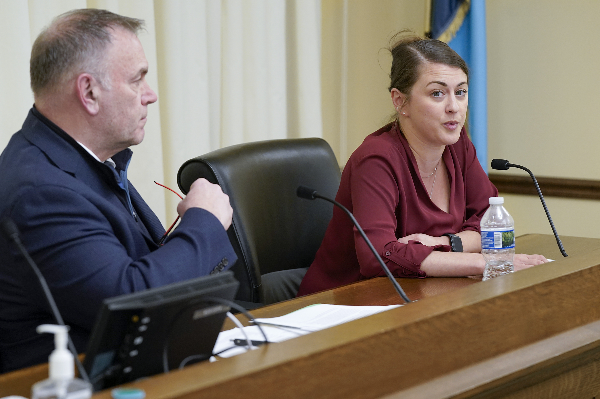 Alicia House, executive director of the Steve Rummler HOPE Network, testifies in support of HF1379 before the House Health Finance and Policy Committee March 10. The bill is sponsored by Rep. Dave Baker, left. (Photo by Michele Jokinen)